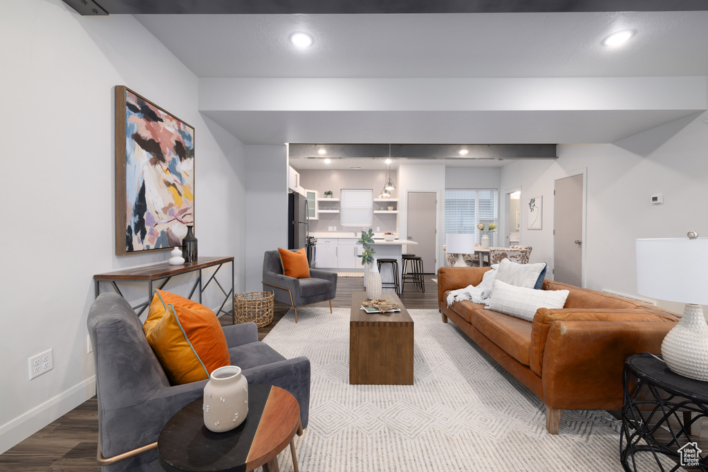Living room featuring light wood-type flooring, recessed lighting, and baseboards