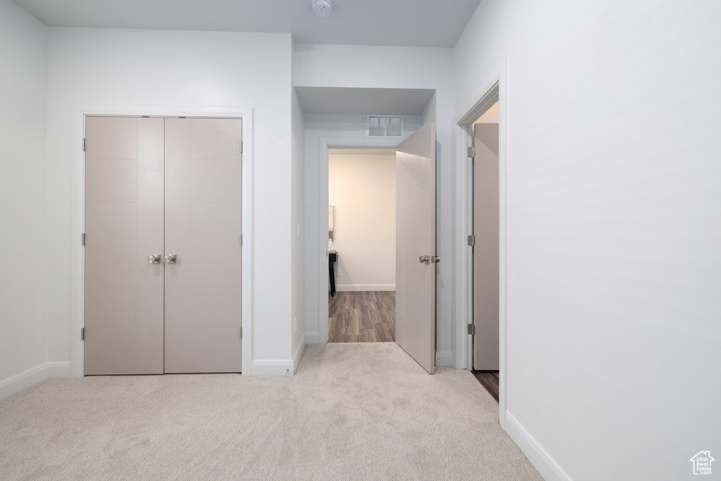 Unfurnished bedroom featuring carpet floors, baseboards, and a closet
