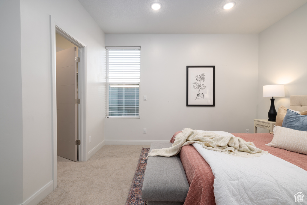 Bedroom with baseboards, light carpet, and recessed lighting