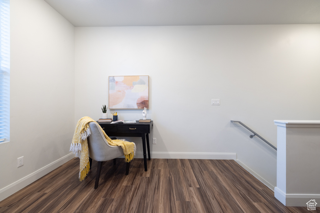 Office space with baseboards and dark wood-type flooring