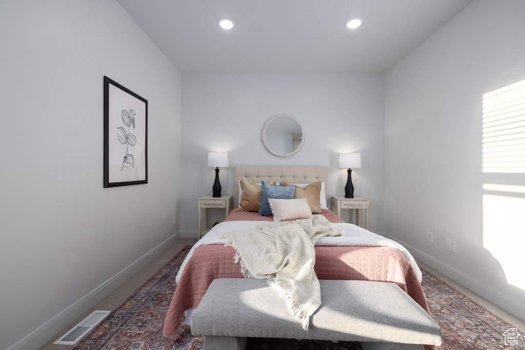 Carpeted bedroom with baseboards, recessed lighting, and visible vents