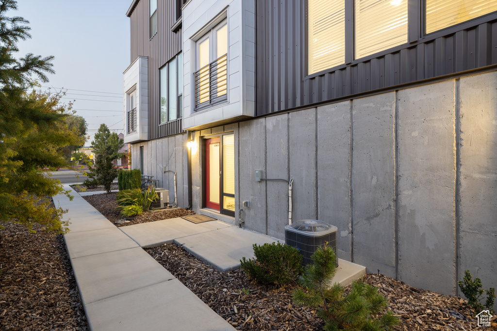 View of home's exterior featuring board and batten siding and cooling unit