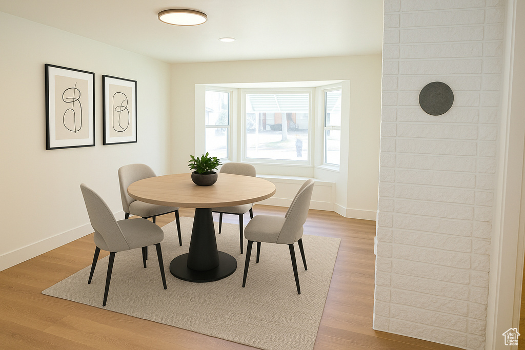 Dining space with baseboards and light wood-type flooring