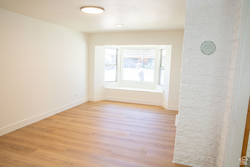 Unfurnished room featuring baseboards and light wood-type flooring