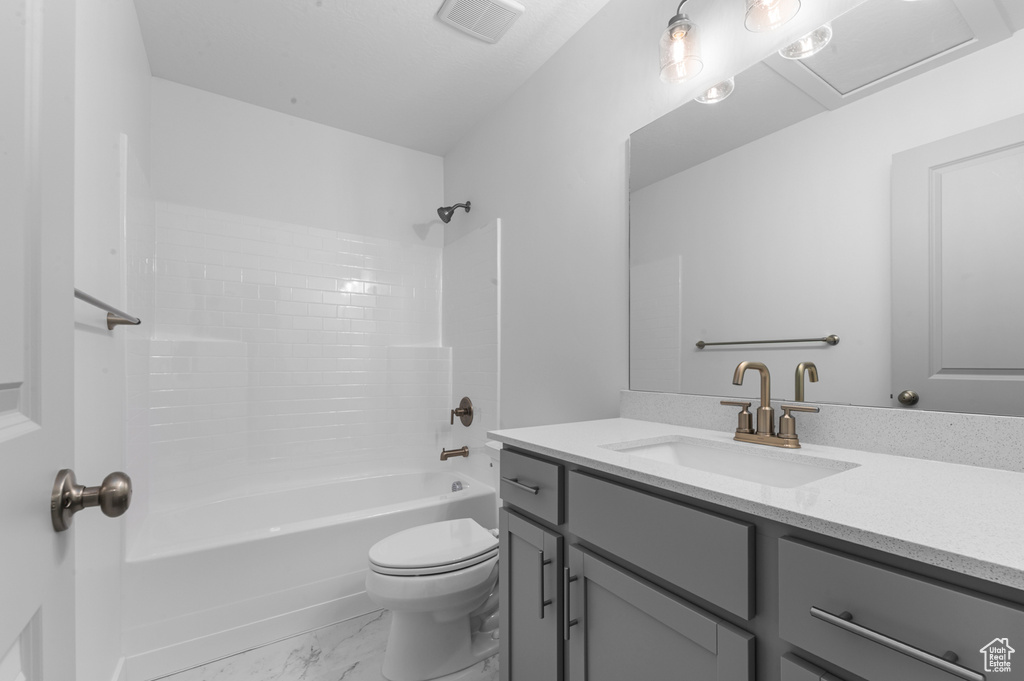 Full bath with shower / tub combination, vanity, toilet, marble finish floor, and visible vents