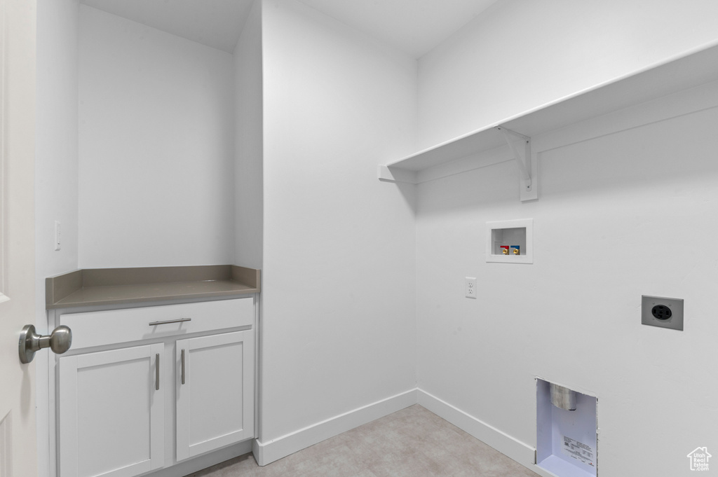 Laundry area with baseboards, cabinet space, electric dryer hookup, and hookup for a washing machine