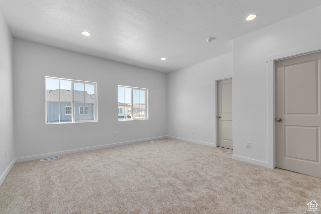 Interior space with carpet floors, recessed lighting, and baseboards