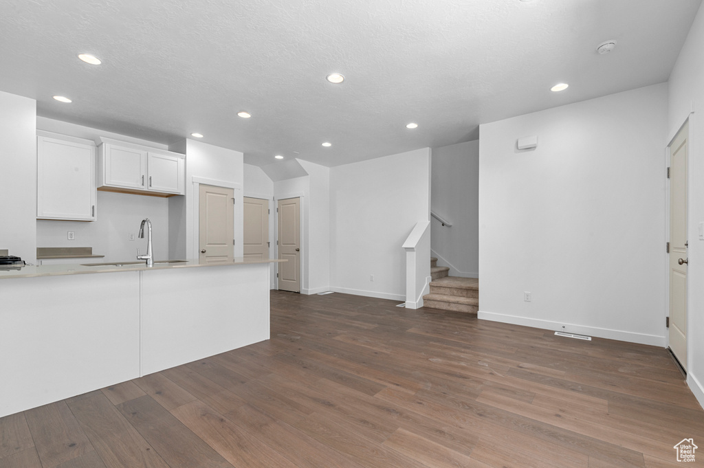 Kitchen with a sink, baseboards, and recessed lighting
