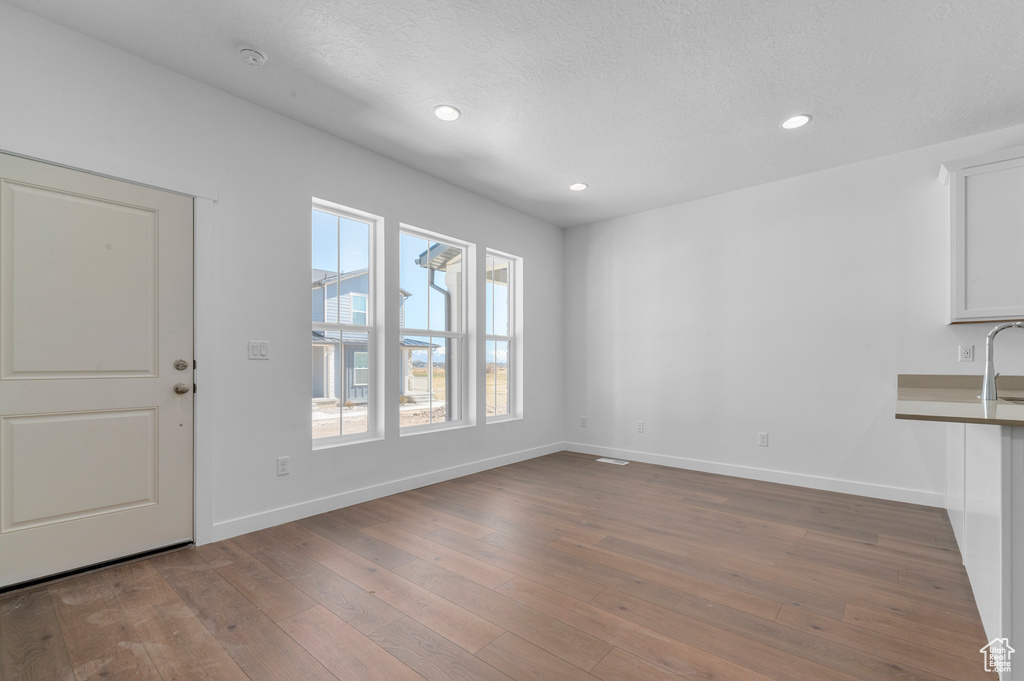 Interior space with recessed lighting, baseboards, and hardwood / wood-style flooring