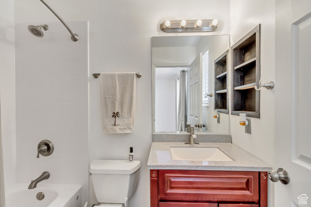 Bathroom with vanity, shower / bath combination, and toilet