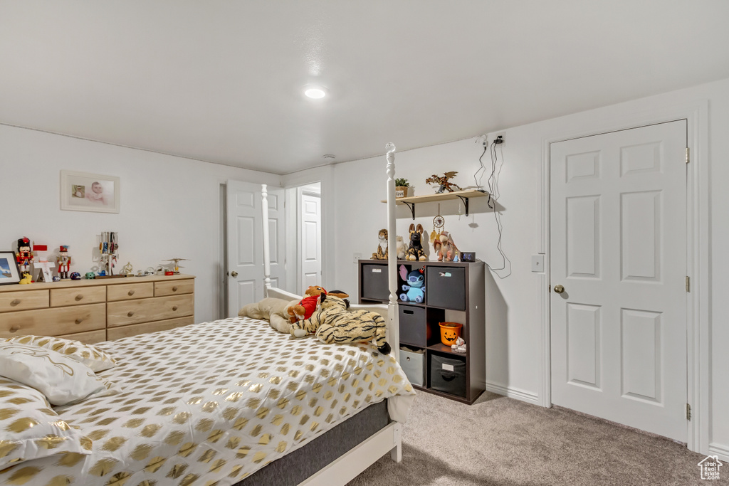 Bedroom featuring carpet floors and baseboards
