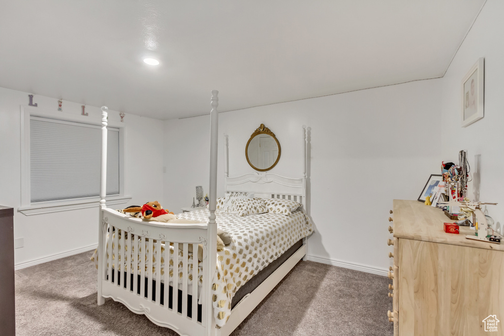 Carpeted bedroom featuring baseboards