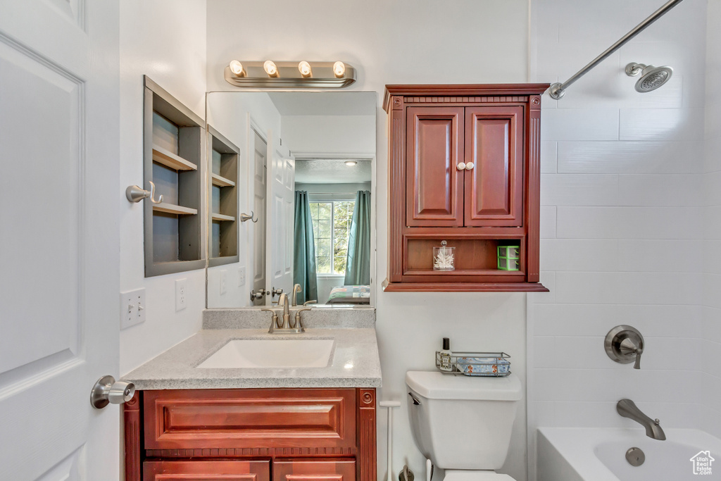 Full bath with vanity,  shower combination, and toilet