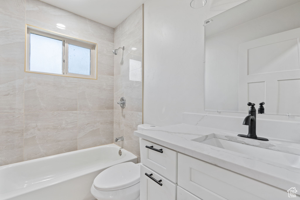 Full bath with vanity, bathing tub / shower combination, and toilet
