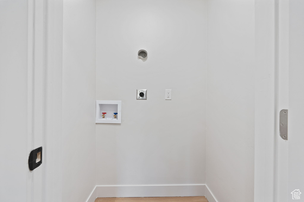 Clothes washing area featuring electric dryer hookup, hookup for a washing machine, baseboards, and laundry area