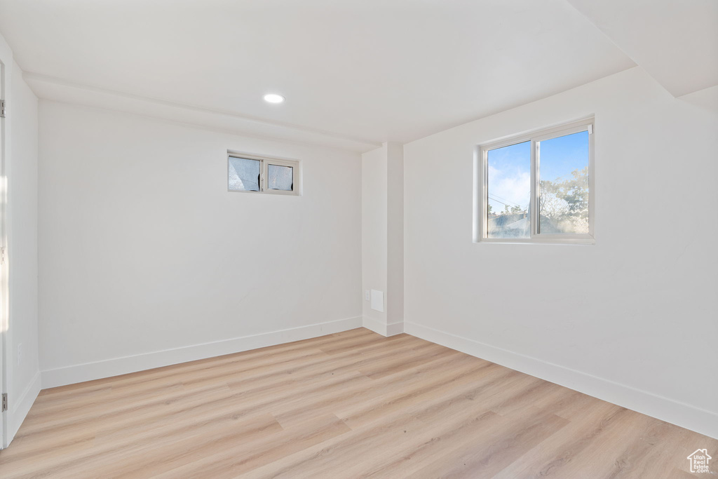 Basement featuring baseboards, recessed lighting, and wood finished floors