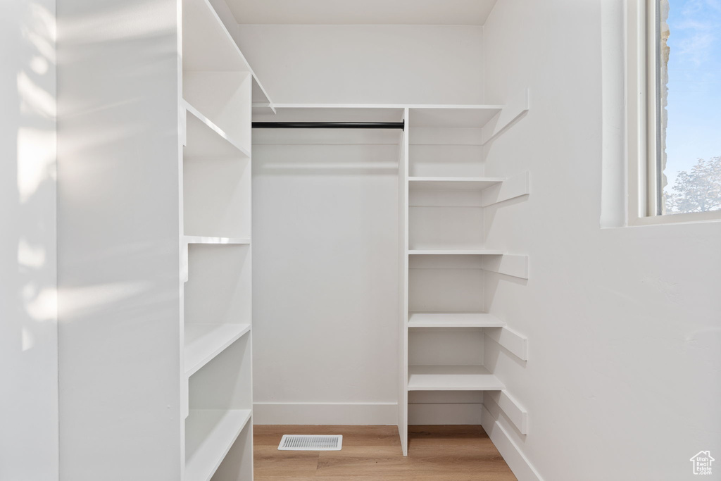 Spacious closet with visible vents and wood finished floors