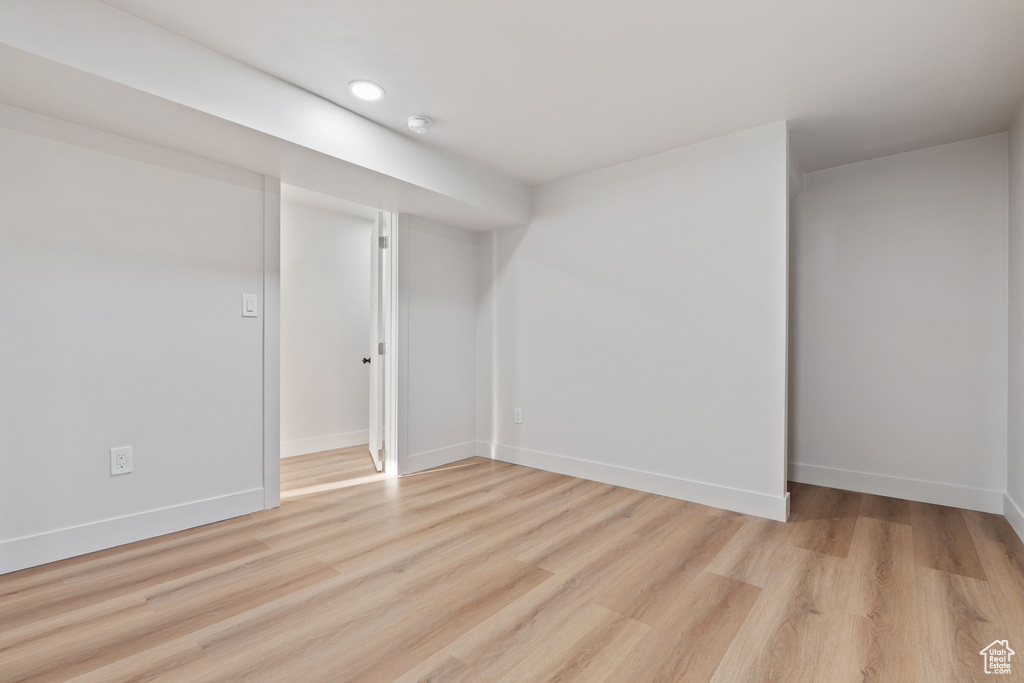 Finished below grade area with recessed lighting, baseboards, and light wood finished floors