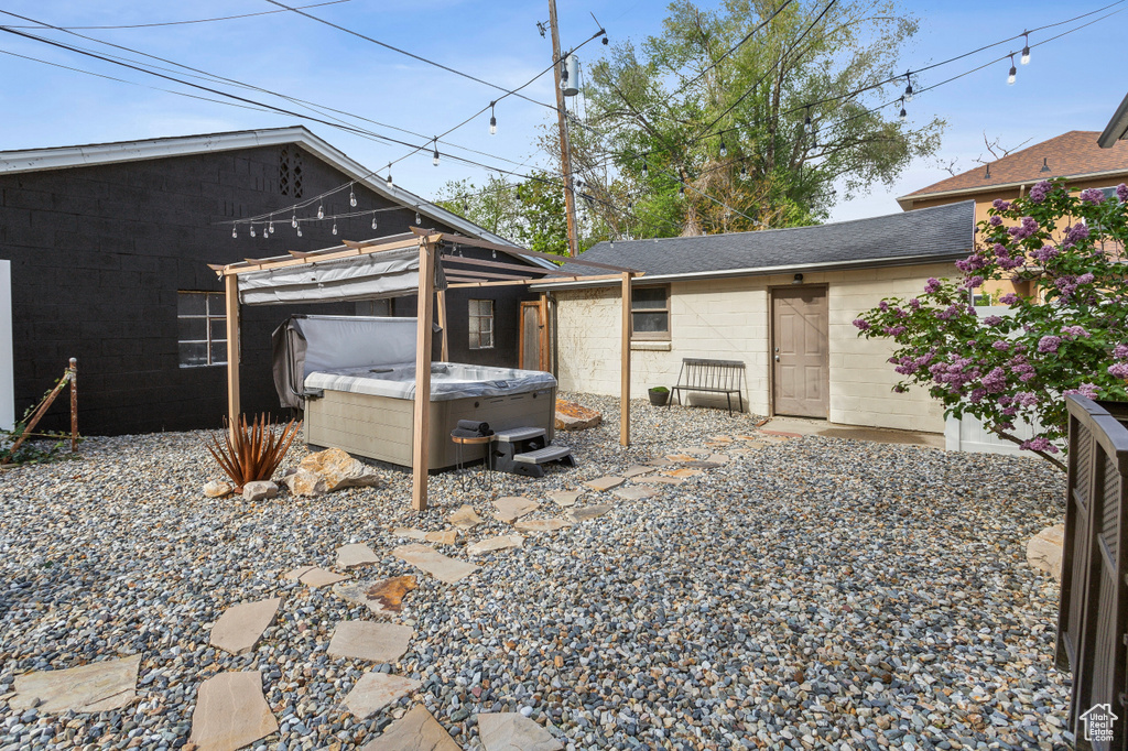 Exterior space with a hot tub