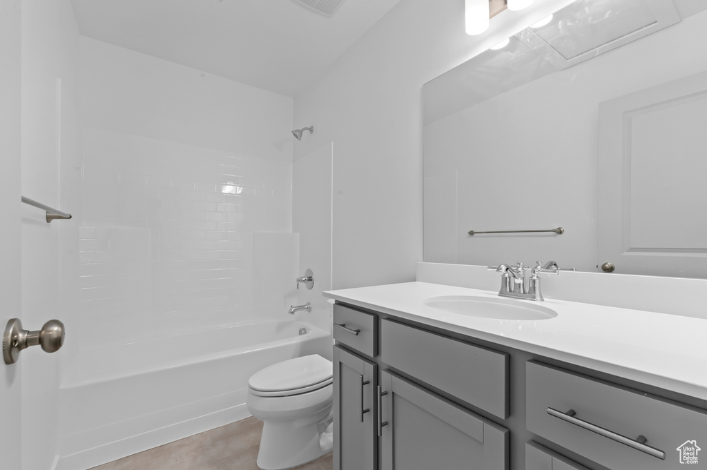 Bathroom with vanity, toilet, and shower / washtub combination
