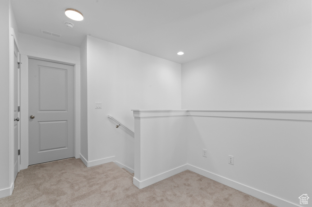 Walk in closet with light carpet and visible vents
