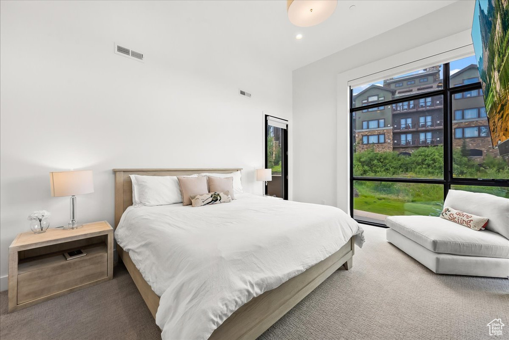 Carpeted bedroom with visible vents and recessed lighting