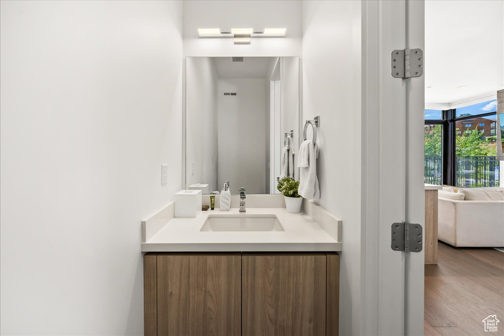 Bathroom with vanity and wood finished floors