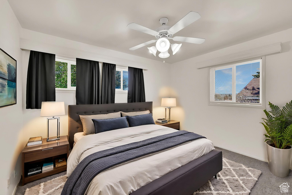 Bedroom with carpet floors, ceiling fan, and baseboards