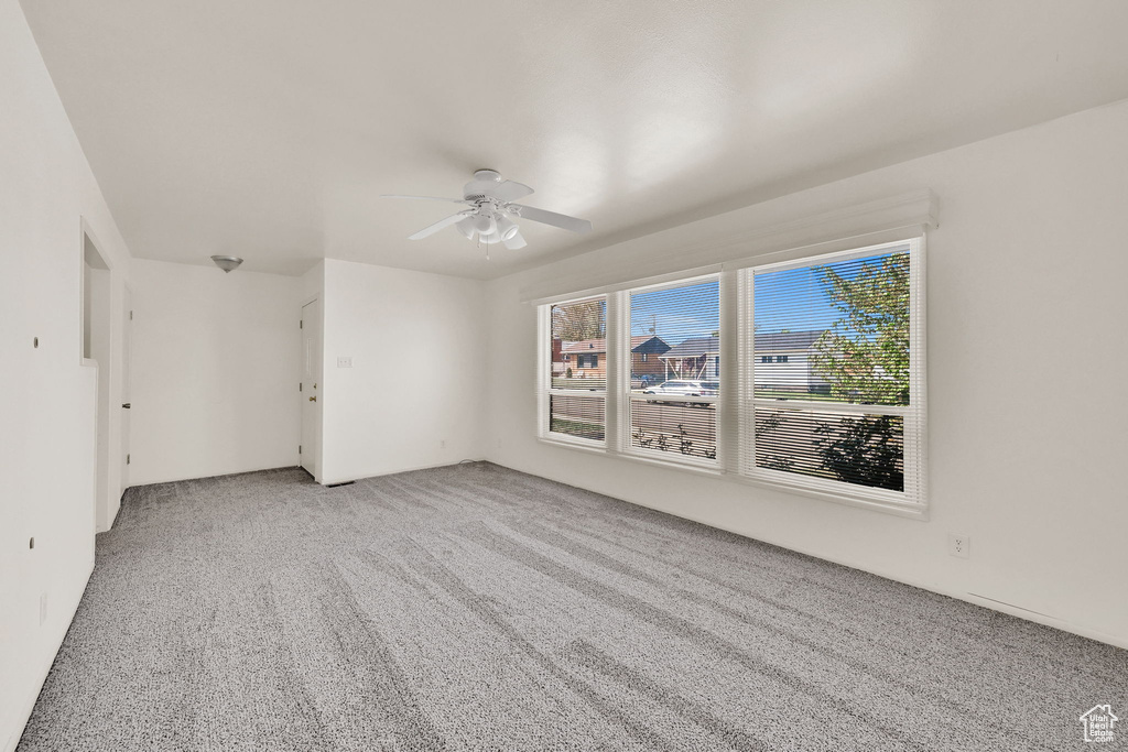 Empty room with carpet flooring and ceiling fan