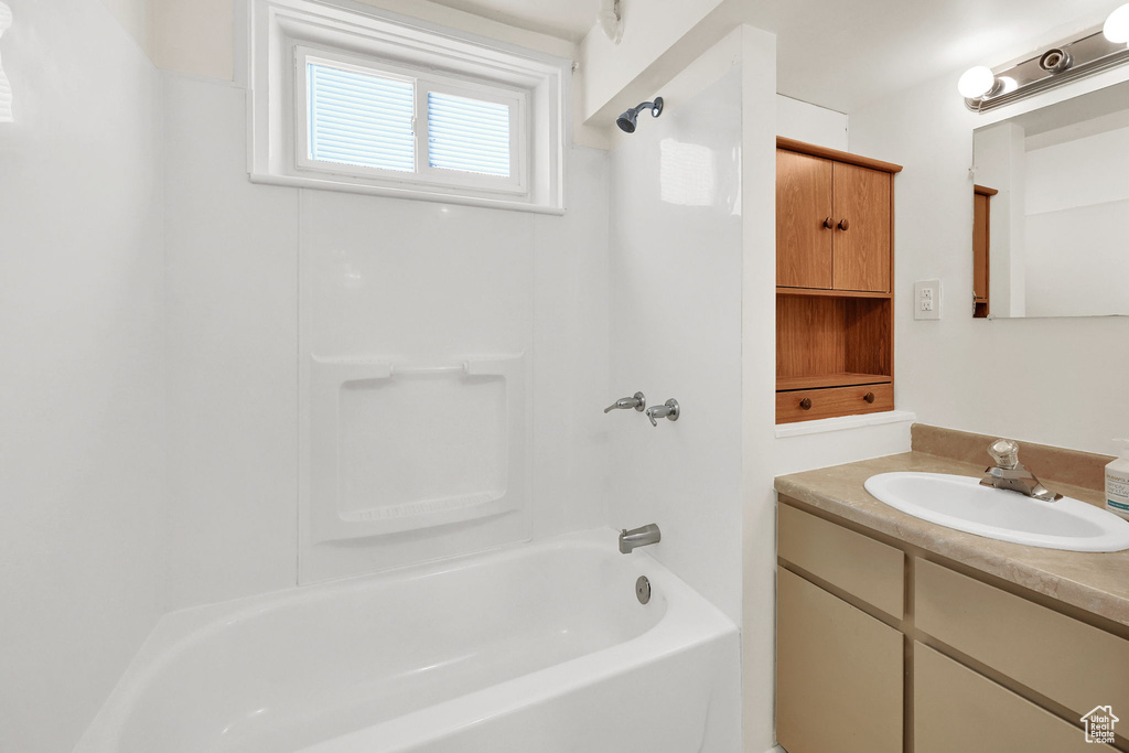 Full bathroom featuring washtub / shower combination and vanity