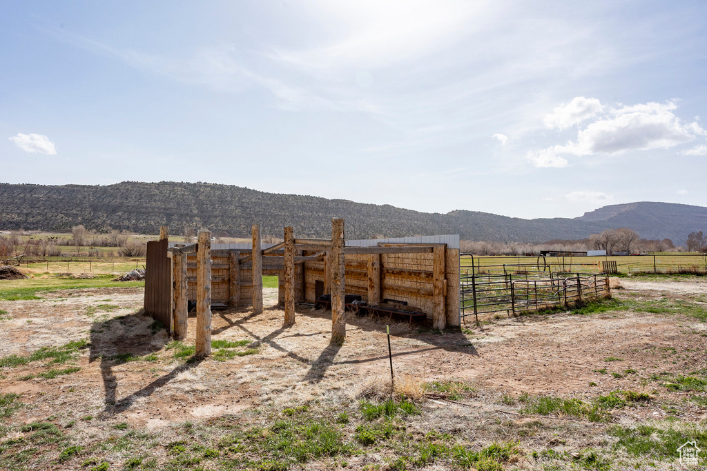 View of yard featuring fence, a mountain view, and a rural view