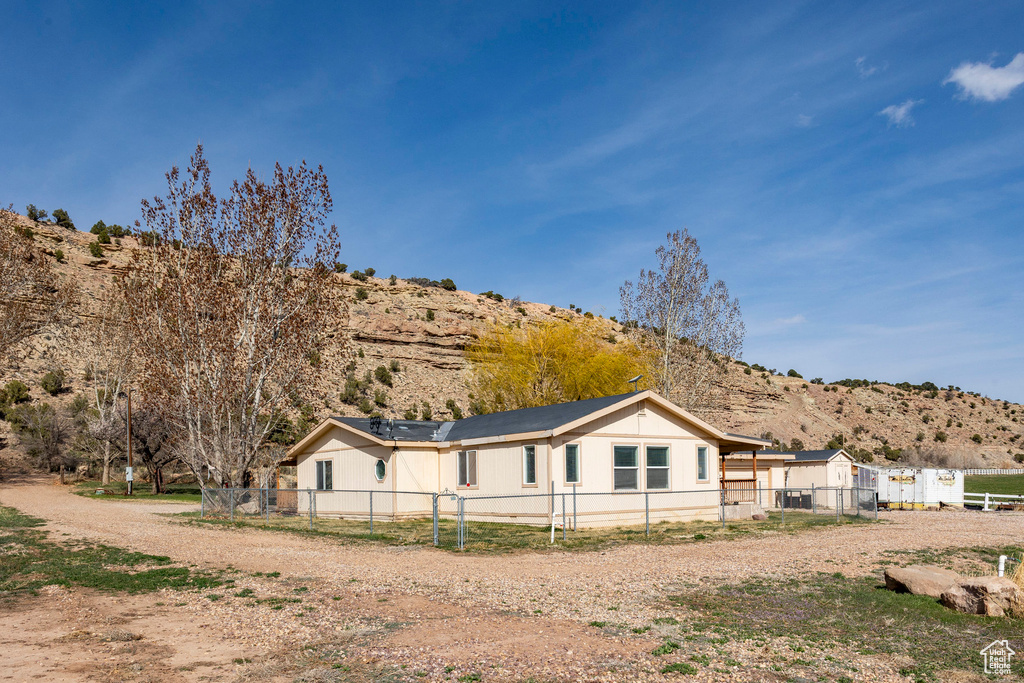 View of side of home featuring fence private yard and a mountain view