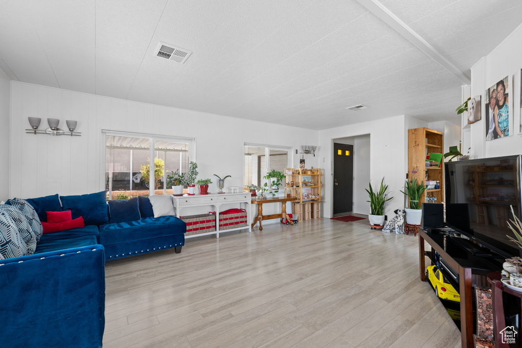 Living area with visible vents and wood finished floors