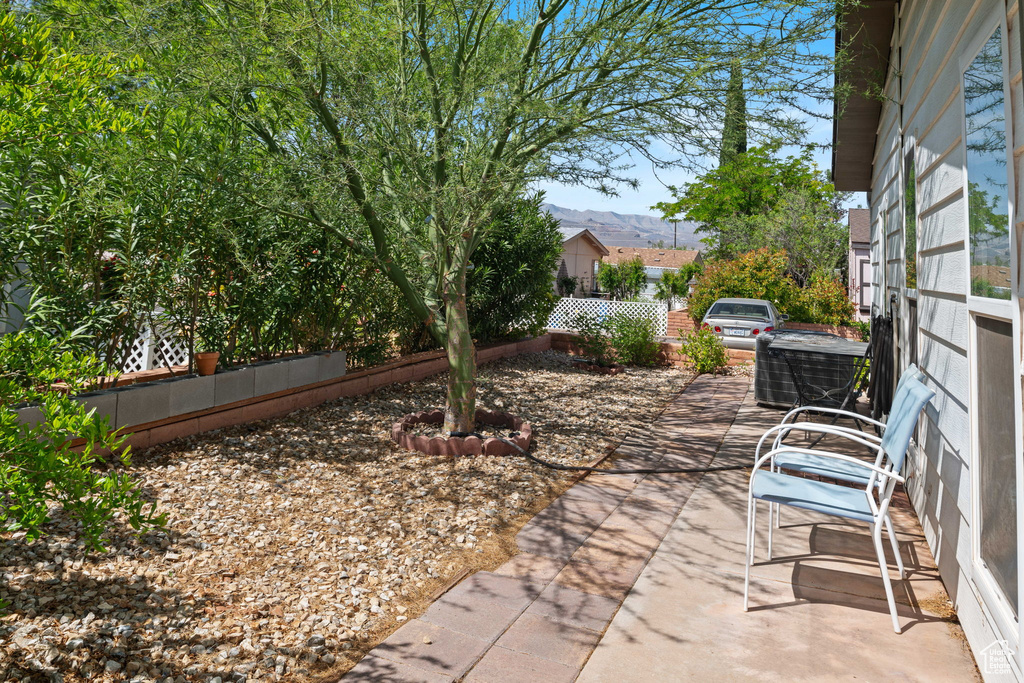 View of patio featuring fence and a mountain view