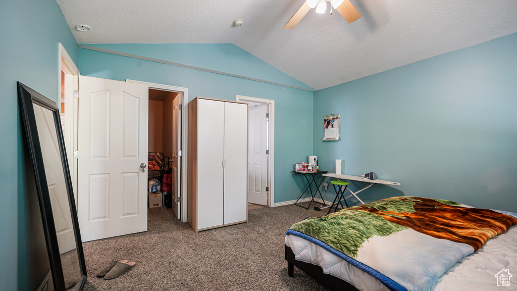 Bedroom featuring vaulted ceiling, carpet floors, baseboards, and a ceiling fan