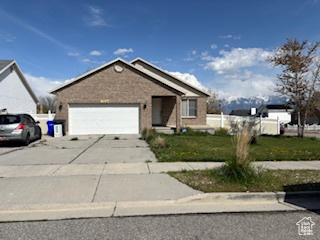 View of front of house featuring an attached garage and concrete driveway