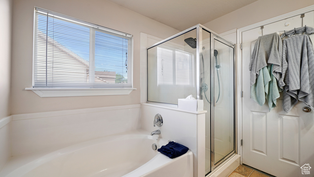 Full bathroom with a garden tub and a stall shower