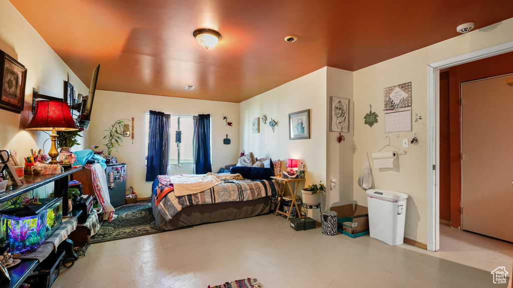 Bedroom featuring finished concrete floors