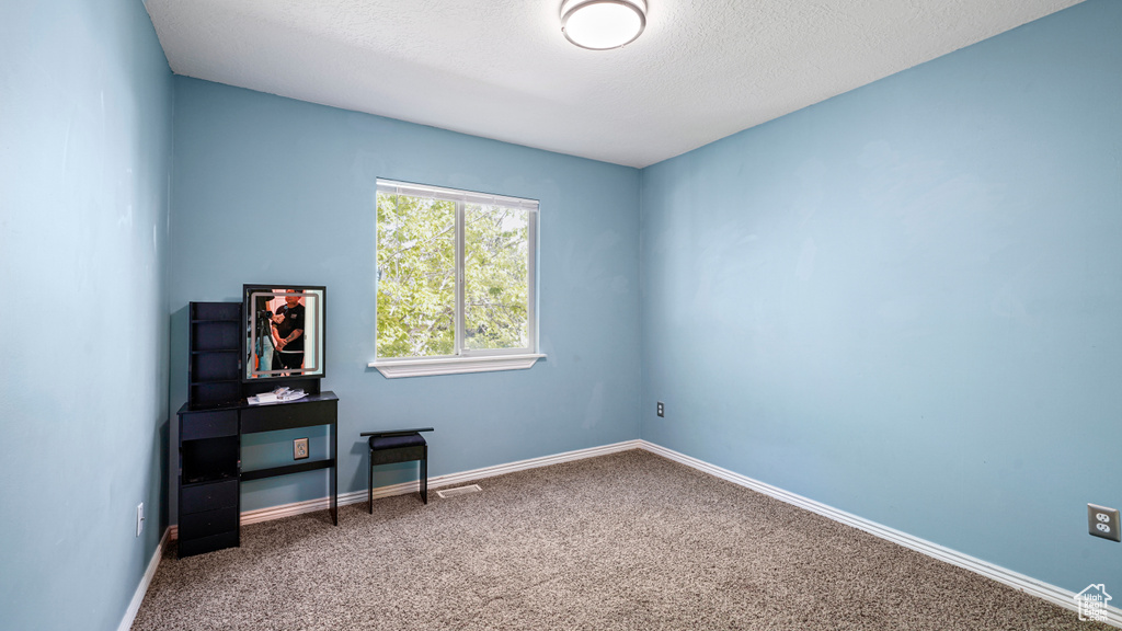Carpeted spare room with baseboards