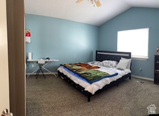 Bedroom with baseboards, a ceiling fan, carpet flooring, and lofted ceiling
