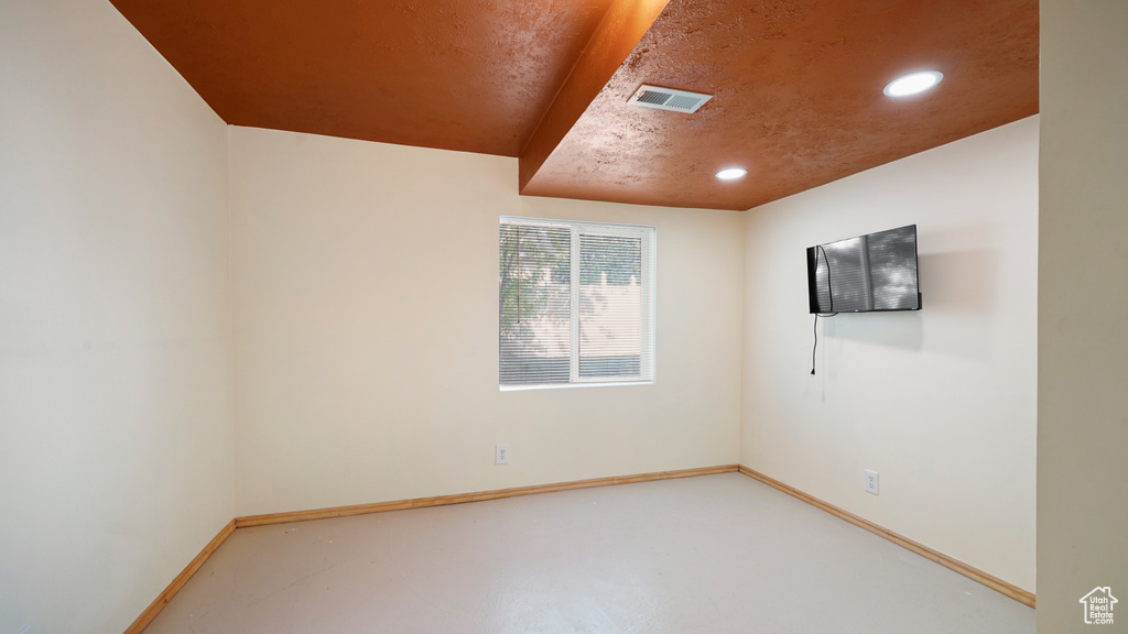 Spare room featuring baseboards and recessed lighting