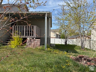 View of side of property with a yard and fence private yard