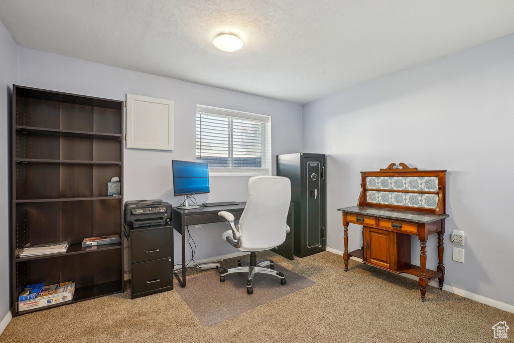 Carpeted office space with baseboards