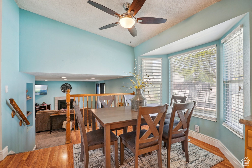 Dining space with ceiling fan, baseboards, and light wood-type flooring