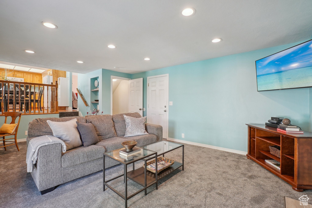 Living area with stairway, baseboards, carpet flooring, and recessed lighting