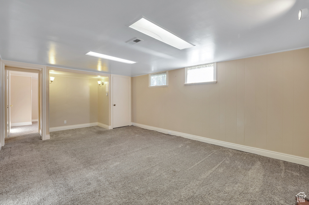 Basement with visible vents and carpet flooring