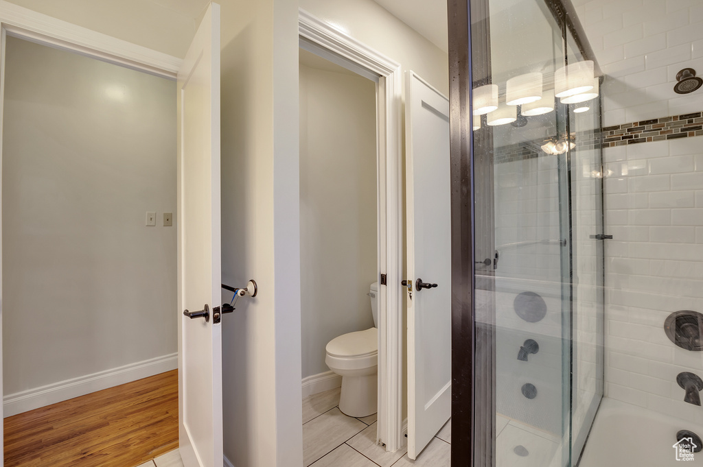Bathroom with baseboards, toilet, and wood finished floors