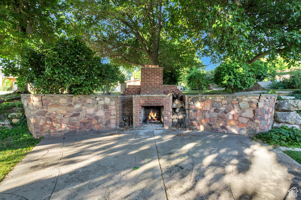 View of gate with an outdoor brick fireplace