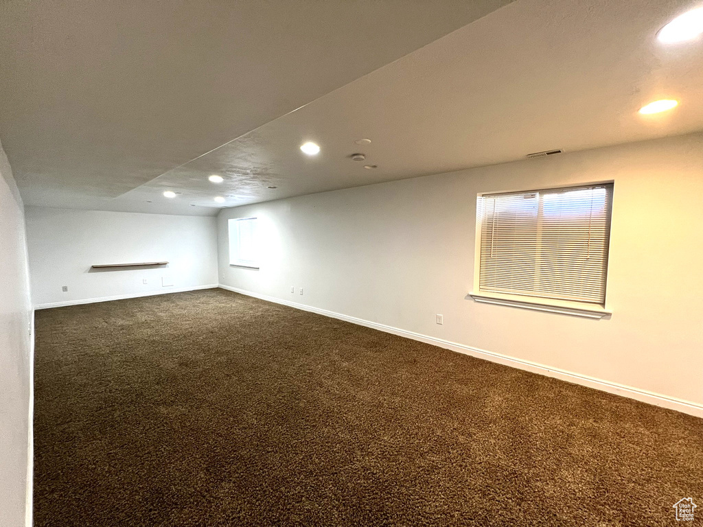 Basement with recessed lighting, baseboards, and dark carpet