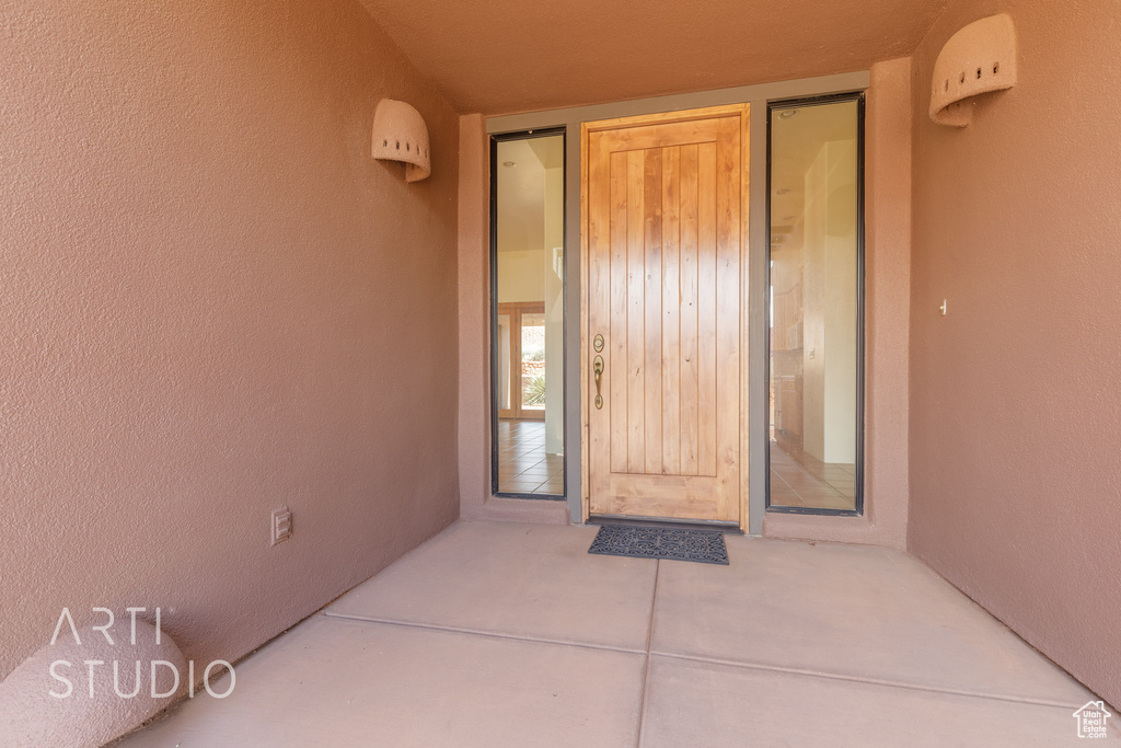 View of exterior entry featuring stucco siding